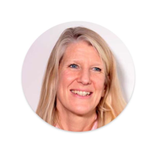 Smiling blonde woman with blue eyes in a circular frame.