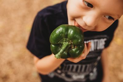 Child eating a green pepper.
Photo by Alexandria Mooney Photography