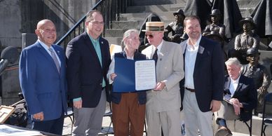NYS officials congratulate Lock Tenders Tribute artist Susan Geissler. 
