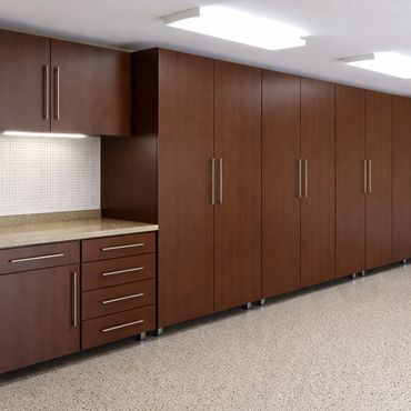 Long row of sleek brown cabinets with a countertop and overhead lighting.
