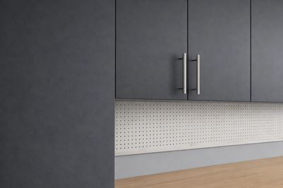 Modern kitchen with gray cabinets and a wooden countertop.