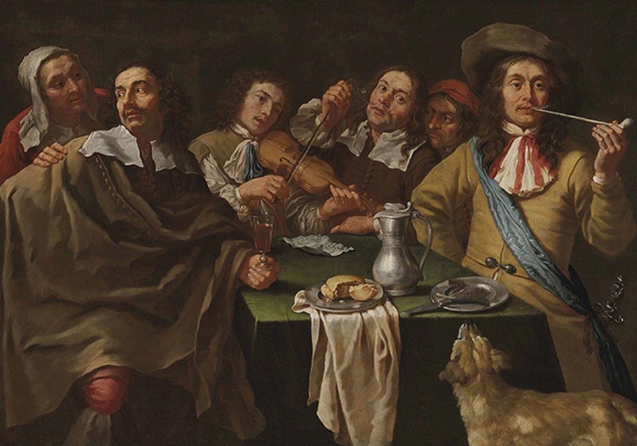 Group of men at a table with musical instruments and food.