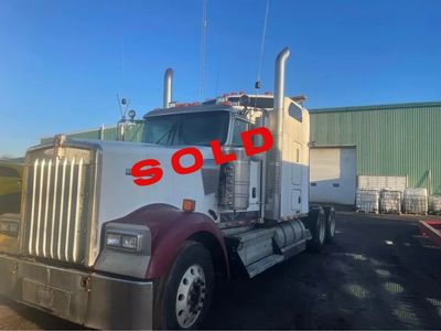 Large semi-truck with "SOLD" written on the windshield.