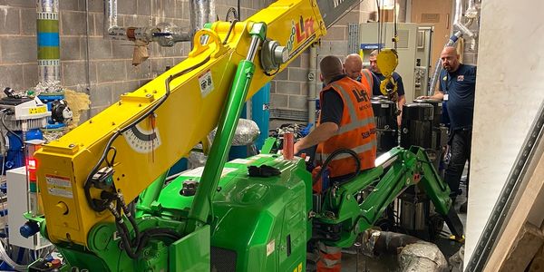MPD Pumps engineers using specialized lifting equipment for plant room pump installation.