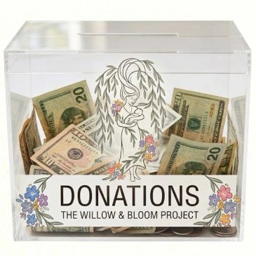 Donation box filled with cash for The Willow & Bloom Project.