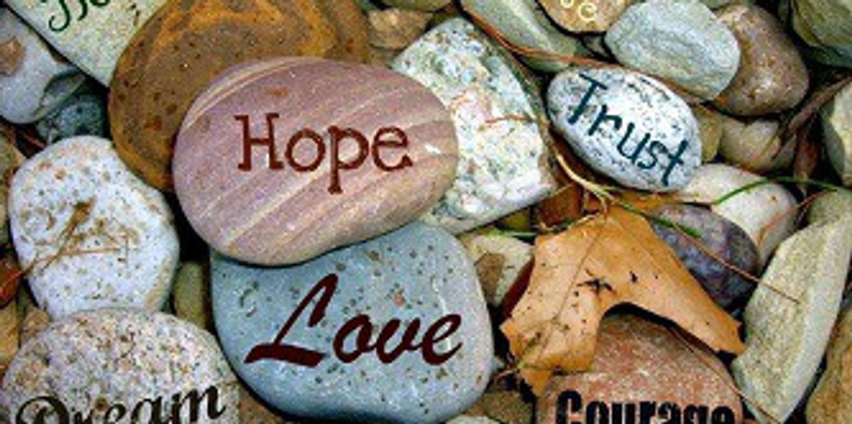 Encouraging words on pebble stones.