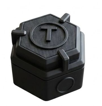 Black hexagonal device with a T logo on top.