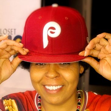 Person wearing a red Philly baseball cap and smiling.