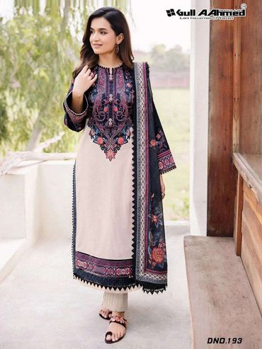 Woman in elegant embroidered lawn dress with floral motifs and matching dupatta.