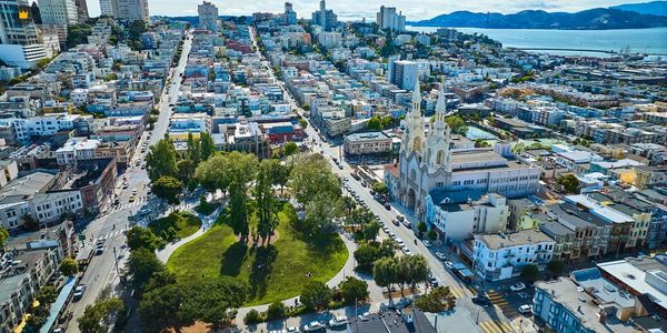 Aerial view of a city park and surrounding buildings near the waterfront.