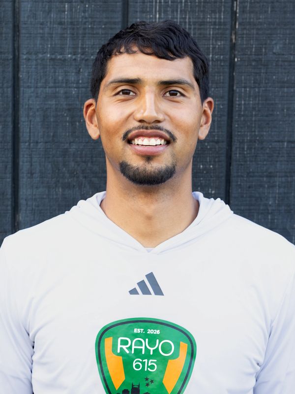 Young man smiling, wearing a white hoodie with a Rayo 615 logo.