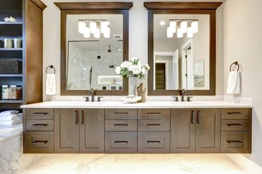 Modern double sink bathroom vanity with dark wood cabinets.