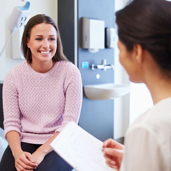 A woman speaking with a doctor