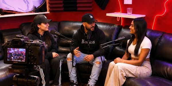 Three people recording a podcast in a studio.