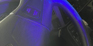 A steering wheel of a fire engine with contamination shown under UV lighting