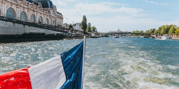 A Parisian passenger boat cruising down the Seine River near the Louvre.