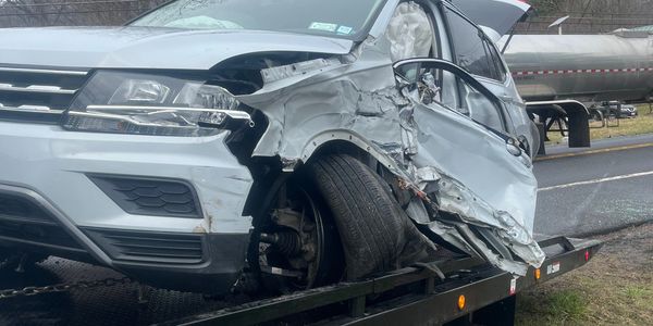 Badly damaged SUV loaded by Danny's Towing after crash near Kingston, NY. Fast 24-hour towing.