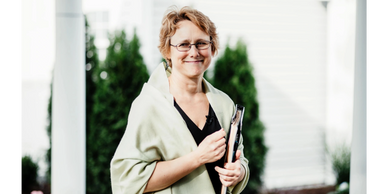 A photograph of an officiant, smiling.