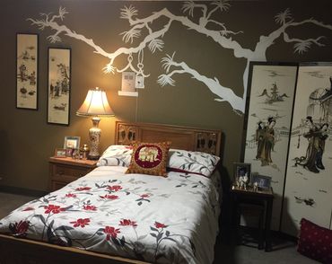 Tree mural over bedroom bed