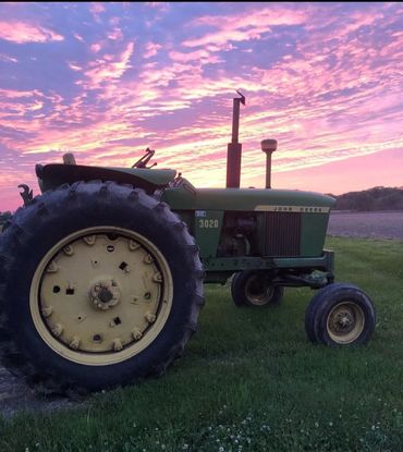 John Deere 3020 tractor with sunset in the background