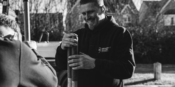 contractor happy whilst installing a driveway guard bollard
