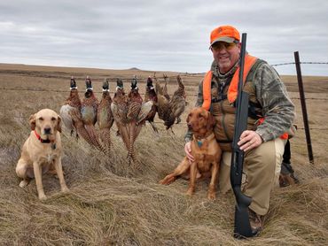 happy hunter with dogs and birds