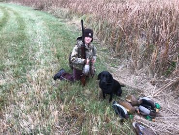 young boy hunter with dog and birds