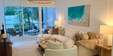 Cozy modern living room with large windows and neutral tones.