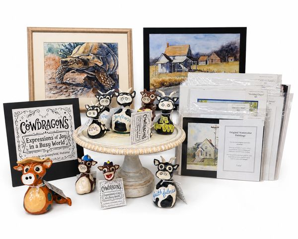 Collection of handcrafted cow-themed figurines and original watercolor paintings.