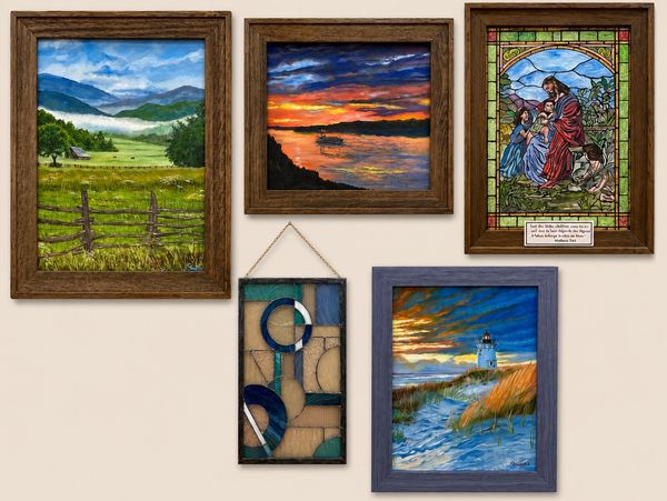 A wall displaying five framed artworks including landscapes and stained glass.