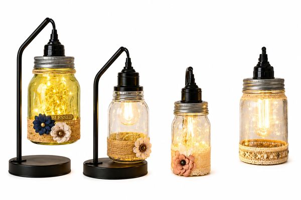 Decorative mason jar lights with floral and burlap accents on black stands.
