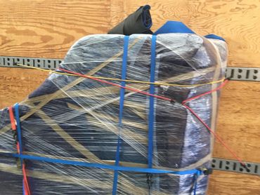 Grand piano wrapped and secured in the truck