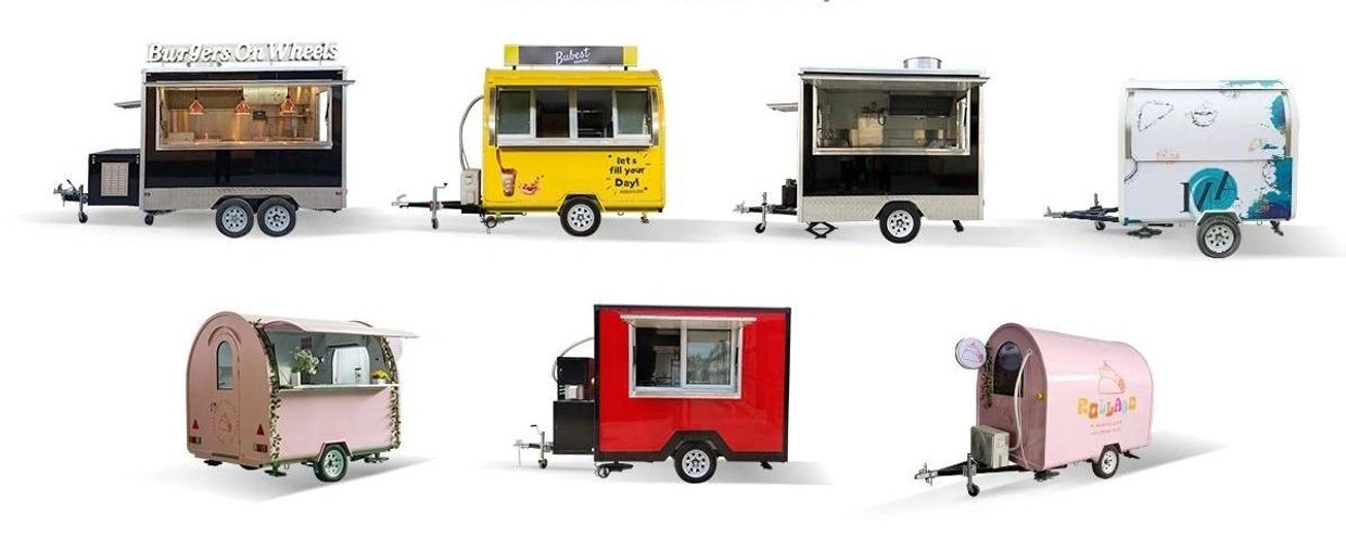 Seven colorful and uniquely designed food trailers lined up in two rows on a white background.