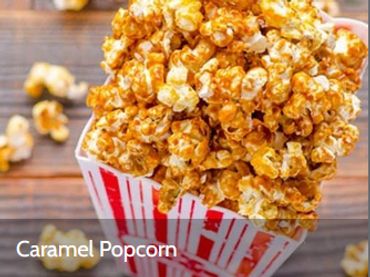 Sweet caramel popcorn in a striped container.