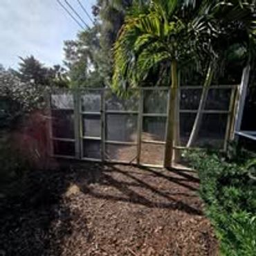Wall to keep chickens on one side of the yard. Wall is 8' tall and enclosed with hardware cloth.