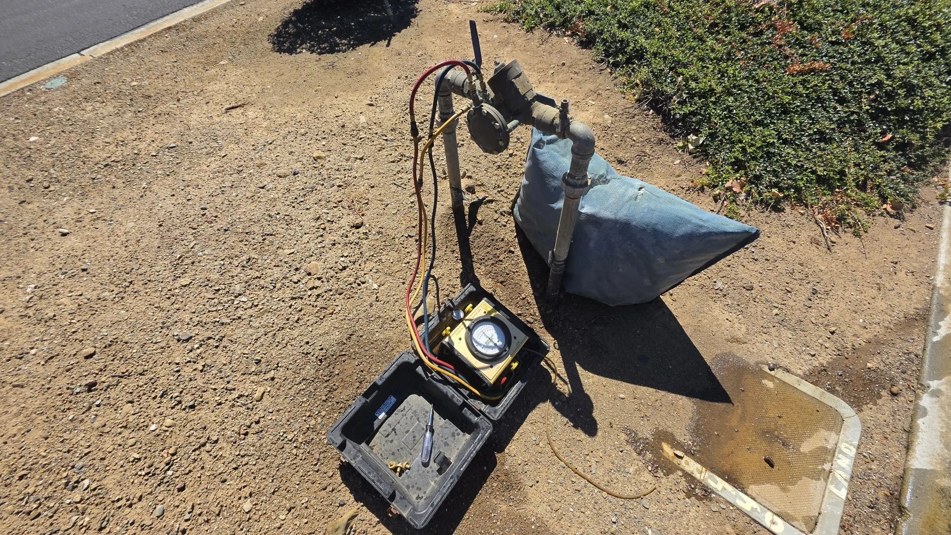Water flow testing device connected to pipes outside.