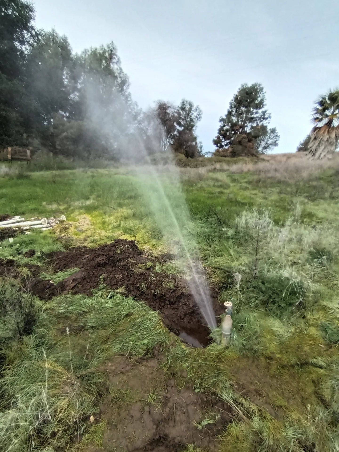 Massive underground water main leak in Morgan Hill spraying into the air.