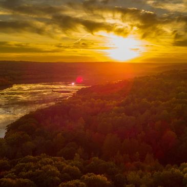 Sunset over New Brunswick lake and surrounding hills.
