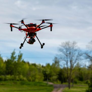 Yuneec H520E Drone flying over country road and field.