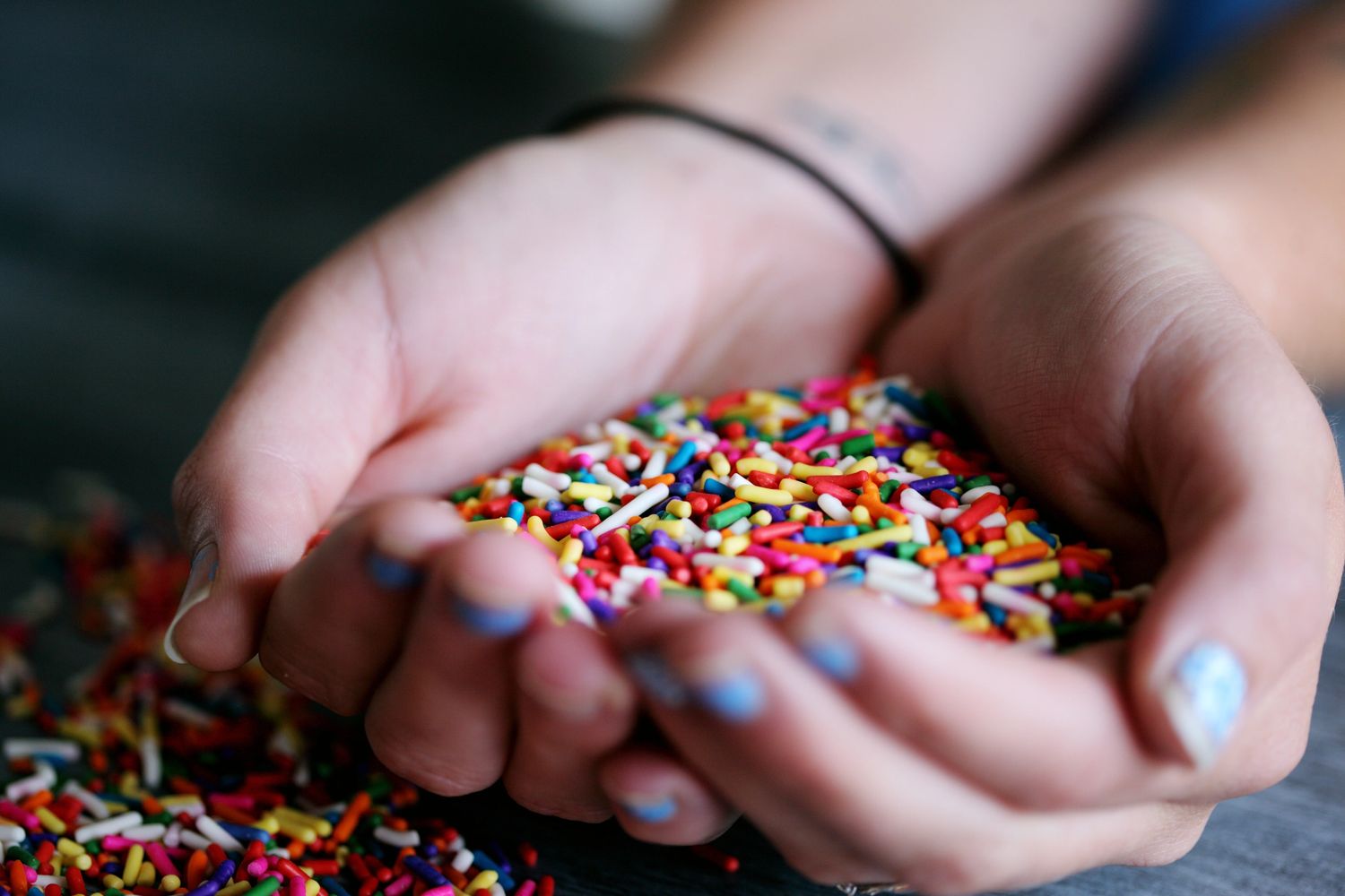 Hands full of colorful jimmie sprinkles