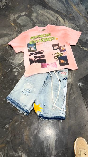 Casual outfit with a pink graphic tee and denim shorts.