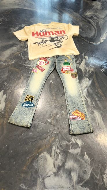 Casual outfit with a graphic t-shirt and patched jeans.