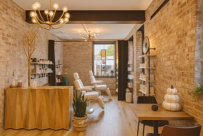 Cozy spa interior with warm lighting and comfortable chairs.