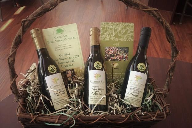 three bottles of olive oil in the basket