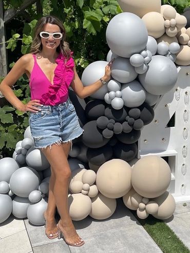 Toronto real estate agent wearing a pink summer outfit and spray tan at a birthday pool party