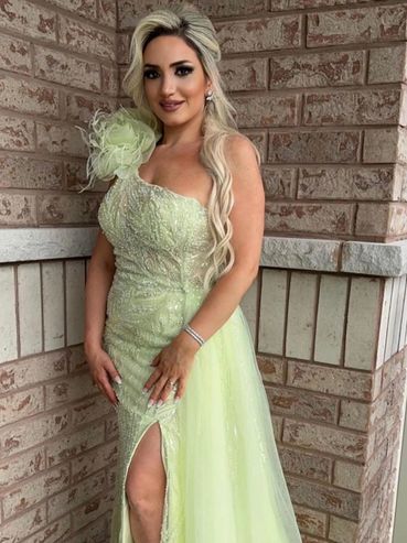 Maid of honour wearing an evening gown and spray tan, with her hair, makeup and nails done