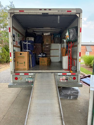 Moving truck loaded with boxes and furniture.