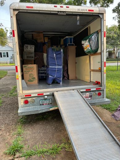 Back of a loaded moving truck with a ramp.