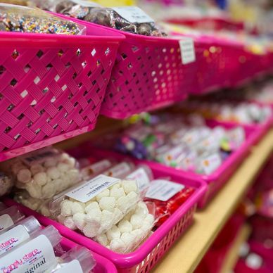 Pink baskets full of a variety of colourful candies