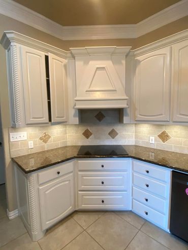Kitchen cabinet painting transformation with modern white finish.